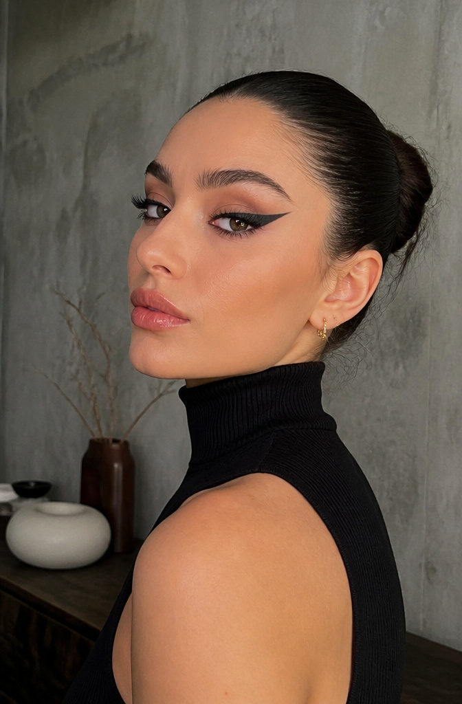 Model showcasing a thick, bold winged eyeliner look.