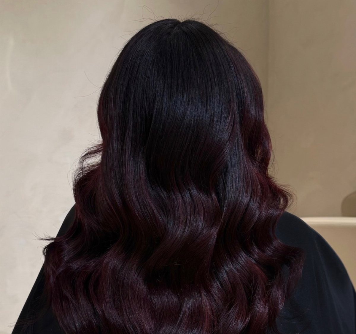 Long wavy hair in a deep dark burgundy winter hair color
